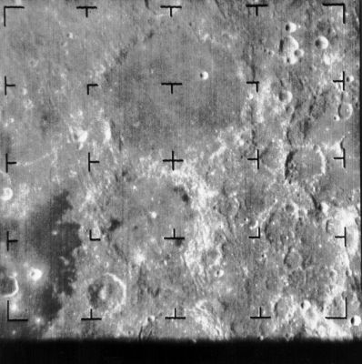 The Moon from Ranger-8: Mare Tranquillitatis (4)
Caption NASA:"The first image taken by the Ranger 8 camera B on 20 February 1965 shows the 164 Km diameter Ptolemaeus Crater, top center, and below it Alphonsus Crater (diameter 108 Km). The Davy Crater Chain can be seen immediately to the right of the left-middle reticle mark as a dotted white line extending S-WW to N-EE. The picture was taken 23 minutes before impact from a range of 2545 Km. 
The image is about 360 Km across and North is up. Ranger 8 was the second successful lunar impact mission in the series (Ranger 8, B001)".
Parole chiave: The Moon